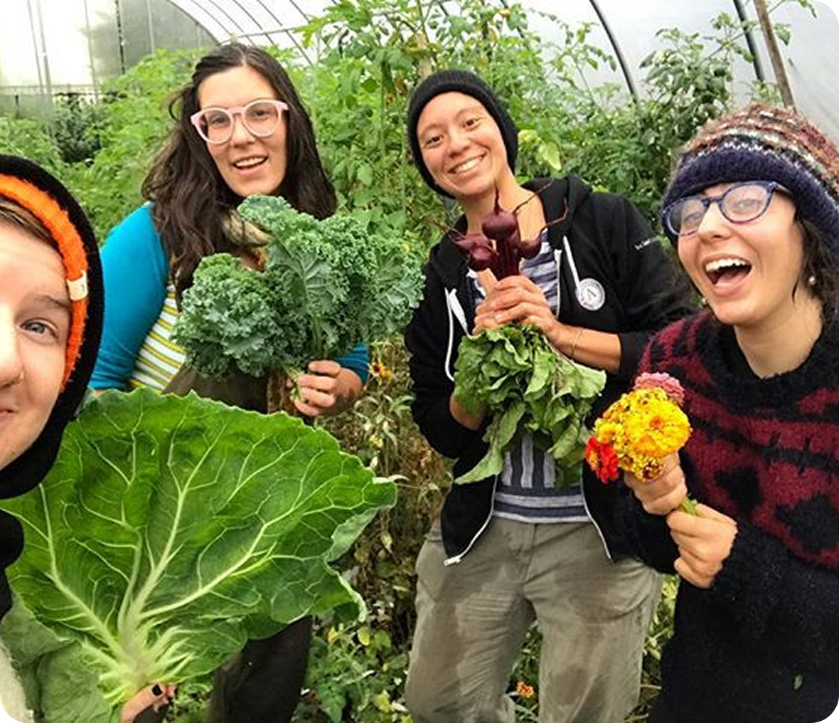 Friends smiling with garden harvest