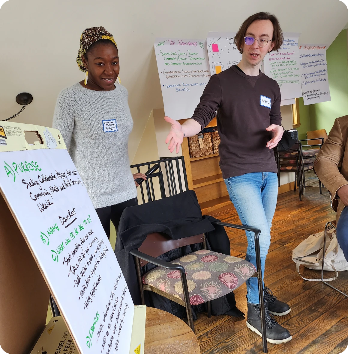 Two people presenting ideas on a board