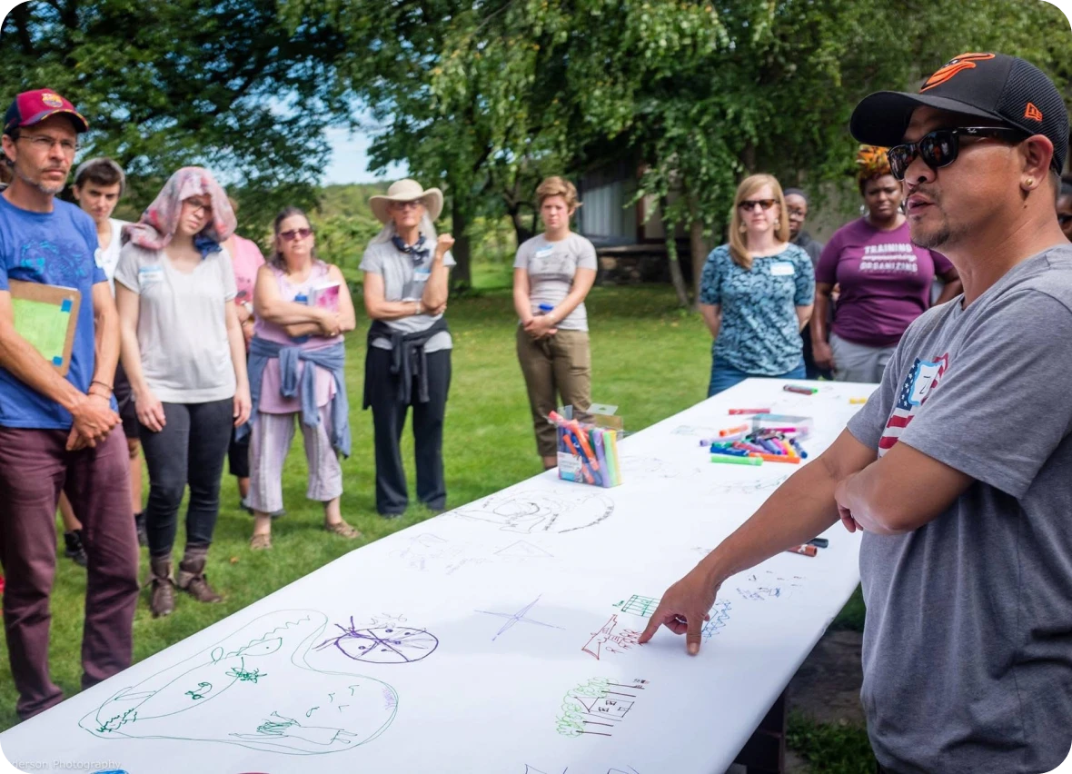 Group discussing sketches on outdoor table