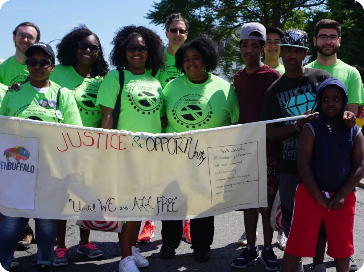 Group holding banner for justice and opportunity