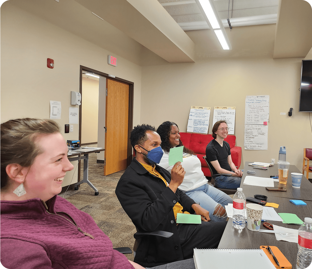 People in a meeting room smiling